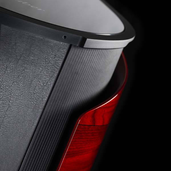 Close-up of Sonus faber's Aida floorstanding loudspeaker in Red high gloss finish with Black leather detailing.