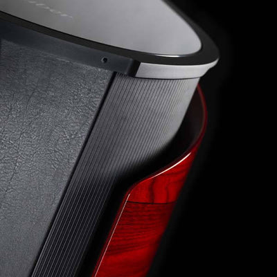 Close-up of Sonus faber's Aida floorstanding loudspeaker in Red high gloss finish with Black leather detailing.