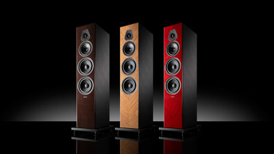 A trio of Sonus faber Lumina V Amator speakers, offered in red, wenge, and walnut high gloss finishes.