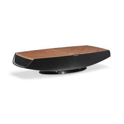 Sonus faber Omnia wireless bookshelf speaker in Walnut, Black fabric, and Aluminum/Titanium finishes.