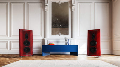 Red-finished Sonus faber Stradivari G2 speakers, framing a table with books in a luxurious room for an elegant audio setup.